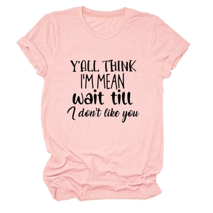Close-up of pink round neck t-shirt with rolled sleeves and black slogan print detail