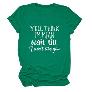 Close-up of green round-neck T-shirt featuring 'Y'ALL THINK I'M MEAN' slogan print