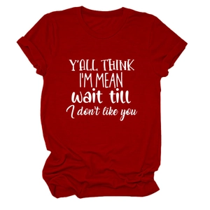 Close-up of red cotton crew neck T-shirt featuring white slogan print and flat lay detail