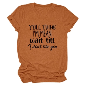 Close-up of rust red t-shirt fabric showing soft texture and artistic slogan print