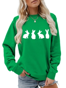 Detail of bright green crewneck sweatshirt with four white rabbit silhouettes and ribbed cuffs