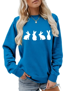 Detail of royal blue oversized sweatshirt featuring white rabbit silhouettes and ribbed cuffs