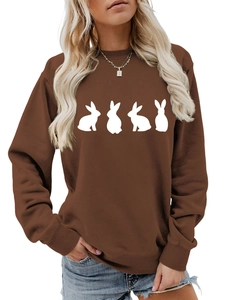 Detail of dark brown crewneck sweatshirt featuring white rabbit silhouettes on the front