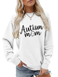 Detail of Autism Mom puzzle print on a white loose-fit crewneck sweatshirt for women