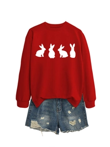 Detailed flat lay of a red bunny print sweatshirt paired with distressed denim shorts
