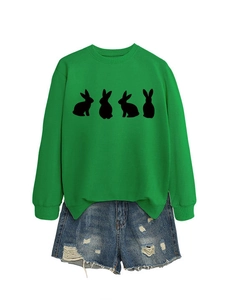 Detail of vibrant green crewneck sweatshirt with black rabbit silhouettes and denim shorts
