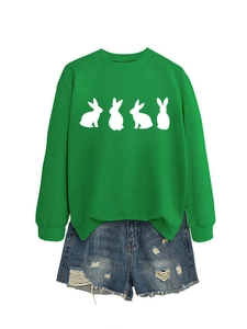 Detail of green crewneck sweatshirt with white rabbit prints and distressed denim shorts