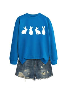 Flat lay of royal blue long sleeve sweatshirt with white rabbit print and denim shorts