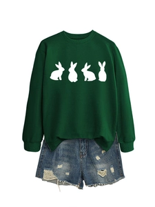 Detail of green crewneck sweatshirt with white rabbit print and ripped denim shorts