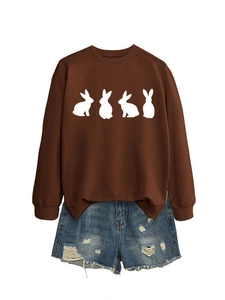 Close-up of brown crewneck sweatshirt featuring four white minimalist rabbit prints