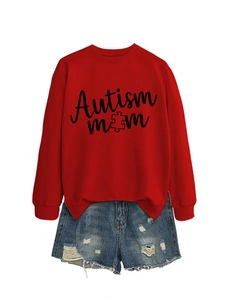 Flat lay of red Autism Mom puzzle graphic sweatshirt paired with distressed denim shorts
