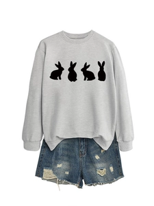 Close-up of light gray crewneck sweatshirt with four black rabbit silhouettes on white background
