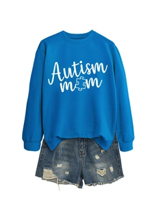 Close-up of Autism Mom blue sweatshirt and distressed denim shorts flat lay set