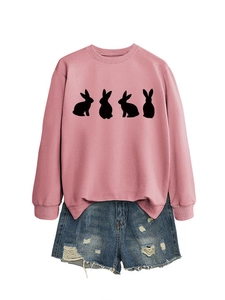 Flat lay of pink crewneck sweatshirt with rabbit silhouettes and distressed denim shorts