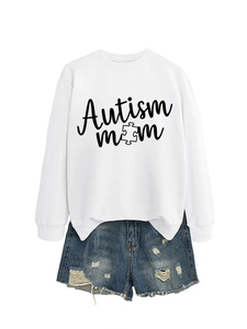 Detailed view of Autism Mom puzzle print on white sweatshirt with denim shorts set