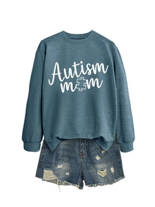 Detail of the blue Autism Mom sweatshirt with puzzle piece graphic and ribbed cuffs