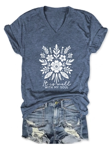 Vue à plat d'un t-shirt bleu col en V avec motif floral et détails du texte artistique