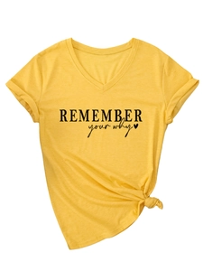 Detail of yellow V-neck T-shirt with Remember Your Why print and waist knot design