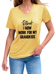 Detail of V-neck yellow shirt with -Retired- I NOW WORK FOR MY GRANDKIDS text print