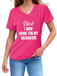 Detail of pink V-neck T-shirt with 'Retired I Now Work For My Grandkids' text and necklace
