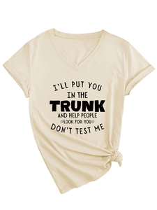 Detail of V-neck apricot t-shirt featuring black slogan print and front hem knot design