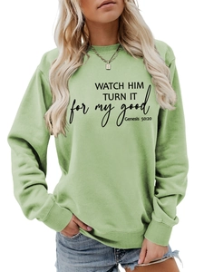 Detail of sage green sweatshirt featuring black inspirational Bible verse print and ribbed cuffs