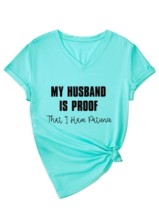 Detail of mint green V-neck T-shirt showing rolled sleeves and printed slogan text