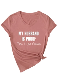 Detail of V-neck dusty rose T-shirt featuring side knot and funny printed slogan