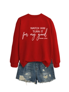 Detail of red crewneck sweatshirt with biblical quote print and distressed denim shorts