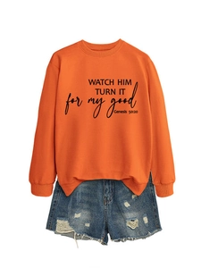 Detail of orange crewneck sweatshirt with black WATCH HIM TURN IT slogan print