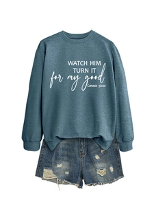 Detailed view of the crewneck sweatshirt fabric and religious print on blue cotton