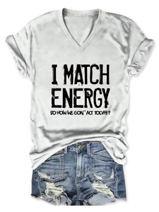 Detail of white V-neck T-shirt with black slogan print paired with denim shorts