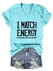 Detail of light blue V-neck T-shirt with black graphic text print and distressed denim shorts