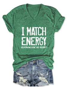 Flat lay of green V-neck T-shirt with text and distressed denim shorts for summer