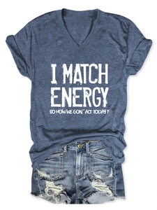 Flat lay of a blue V-neck T-shirt with text paired with distressed denim shorts
