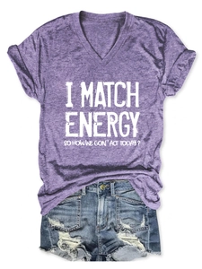 Detailed view of purple V-neck T-shirt with 'I MATCH ENERGY' slogan and denim shorts