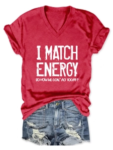 Detail of red V-neck T-shirt with I MATCH ENERGY text paired with distressed denim shorts