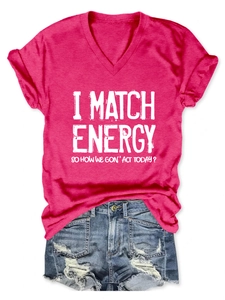 Flat lay of pink V-neck slogan T-shirt paired with distressed blue denim shorts