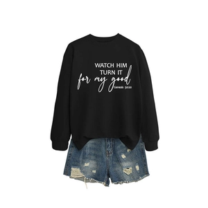 Women's black crewneck sweatshirt with bible quote print and ripped blue denim shorts