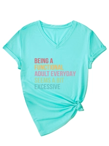 Detail of mint green V-neck T-shirt showing colorful text print and stylish front knot