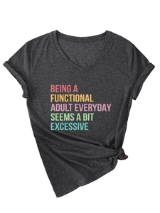 Detail of charcoal grey V-neck t-shirt featuring colorful slogan and stylish bottom knot