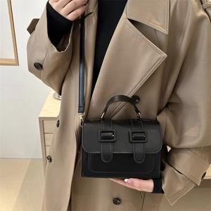 Classic black leather crossbody box bag with dual buckles and vintage top handle