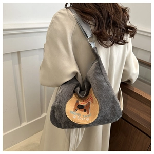 Detail of grey corduroy tote bag with cat embroidery and adjustable metal strap buckle
