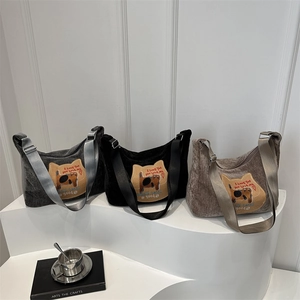 Three corduroy tote bags with cat embroidery and wide straps in black, grey and brown colors