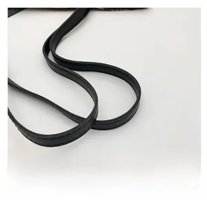 Close-up of black leather shoulder strap with fine stitching details for leopard tote bag