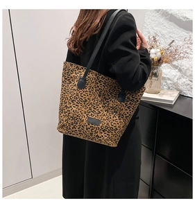 Leopard print tote bag styled with a black blazer in a chic minimalist interior setting