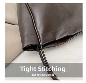 Detail showing high-density stitching and premium leather texture on a tote bag