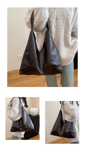 Detail view of a retro dark brown leather tote bag with minimalist triangular silhouette