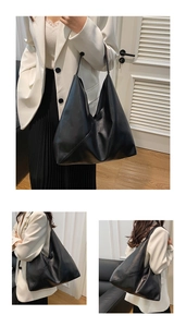 Close-up of a large black faux leather tote bag with unique triangular stitching detail