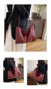 Detailed view of burgundy tote bag with glossy leather texture and slim shoulder strap